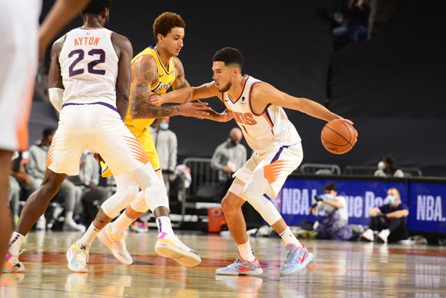 PHOENIX, AZ - DECEMBER 18: Devin Booker #1 of the Phoenix Suns handles the ball against the Los Angeles Lakers during a preseason game on December 18, 2020 at Talking Stick Resort Arena in Phoenix, Arizona. NOTE TO USER: User expressly acknowledges and agrees that, by downloading and or using this photograph, user is consenting to the terms and conditions of the Getty Images License Agreement. Mandatory Copyright Notice: Copyright 2020 NBAE (Photo by Barry Gossage/NBAE via Getty Images)