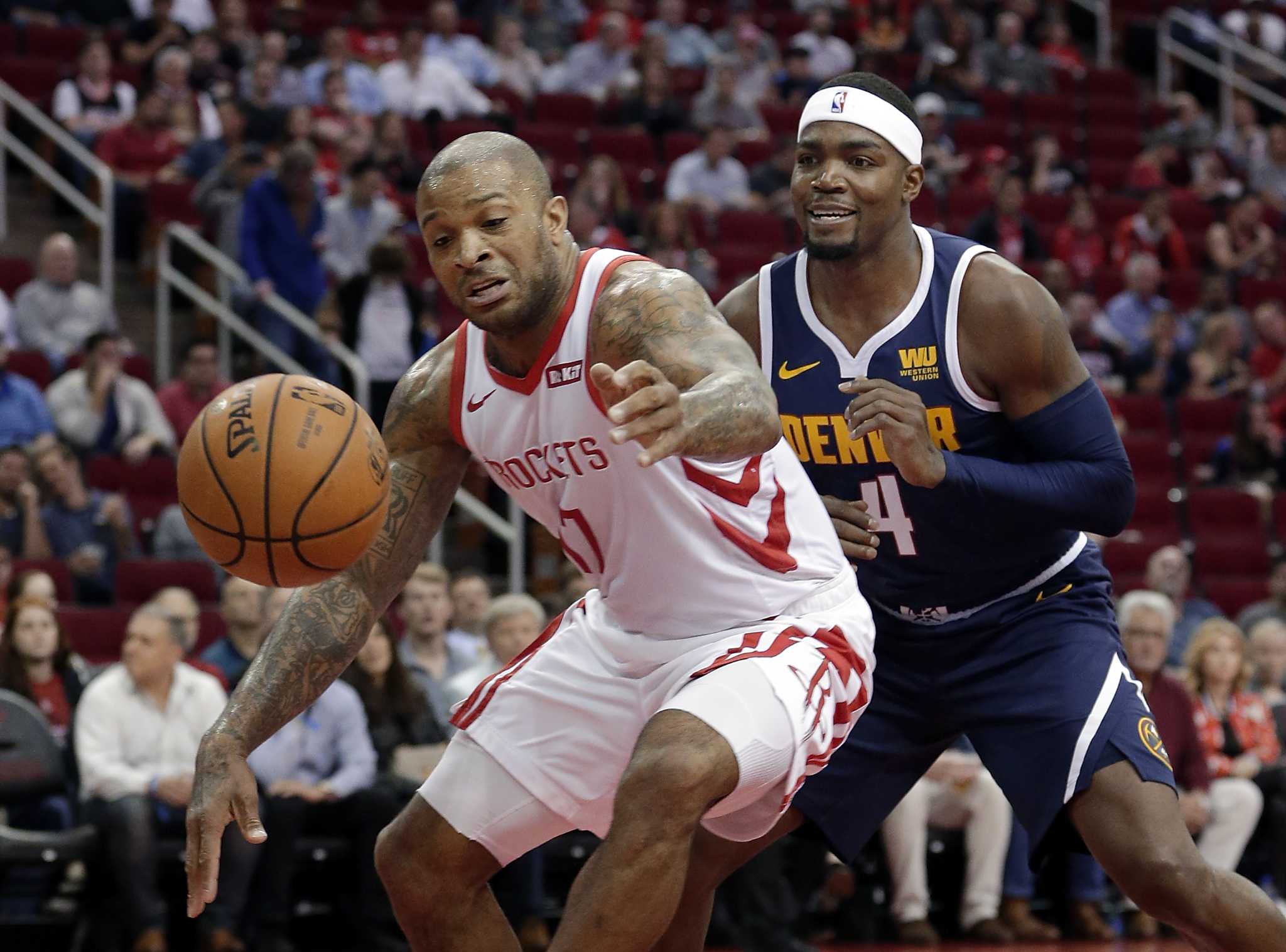 Houston Rockets forward PJ Tucker (17) reaches to recover the ball after it was knocked away by Denver Nuggets forward Paul Millsap (4) during the first half of an NBA basketball game Monday, Jan. 7, 2019, in Houston. (AP Photo/Michael Wyke)