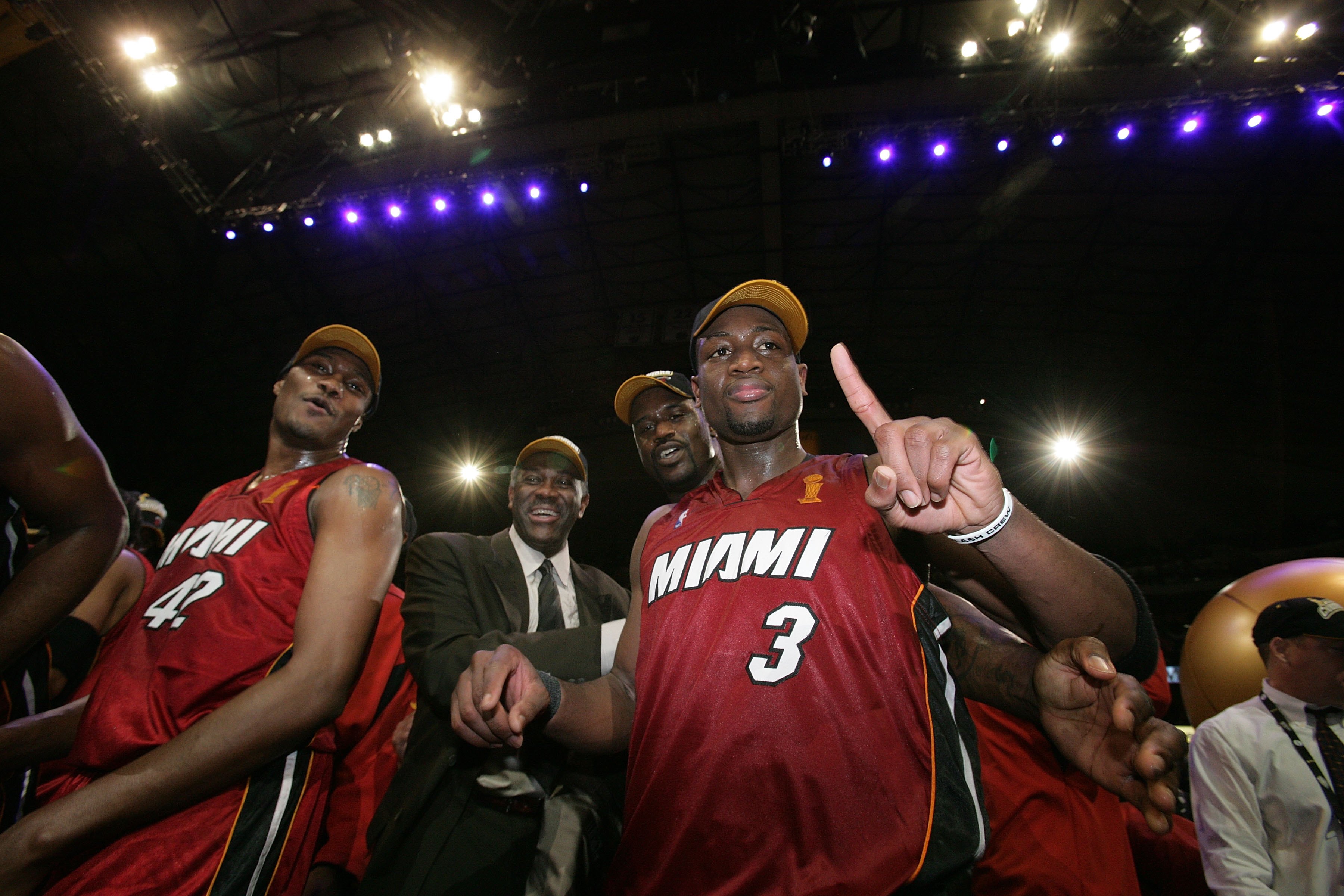 DALLAS - JUNE 20: (L-R) James Posey #42, assistant coach Bob McAdoo, Shaquille O'Neal #32 and Finals MVP Dwyane Wade #3 of the Miami Heat celebrate winning the NBA Championship after the Heat beat the Dallas Mavericks 95-92 in Game Six of the 2006 NBA Finals June 20, 2006 at American Airlines Center in Dallas, Texas. NOTE TO USER: User expressly acknowledges and agrees that, by downloading and or using this photograph, User is consenting to the terms and conditions of the Getty Images License Agreement. Mandatory Copyright Notice: Copyright 2006 NBAE (Photo by Victor Baldizon/NBAE/Getty Images)