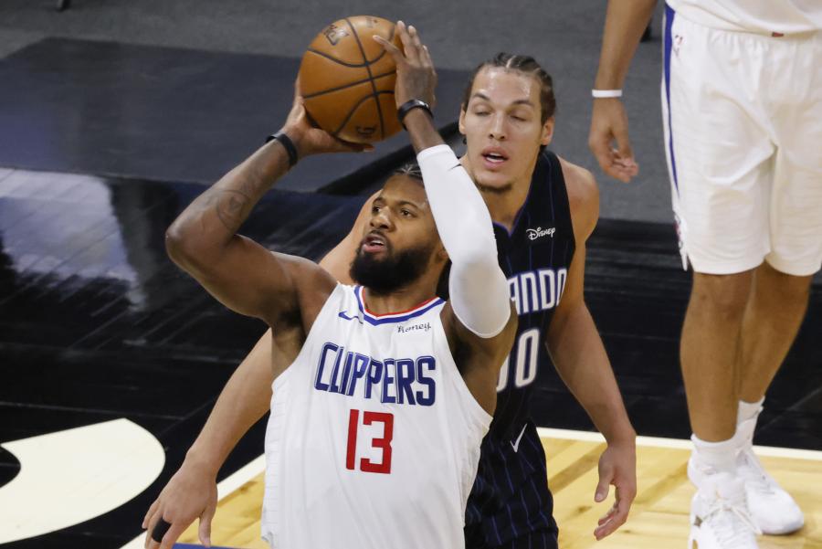 Jan 29, 2021; Orlando, Florida, USA; LA Clippers guard Paul George (13) shoots the ball in front of Orlando Magic forward Aaron Gordon (00) during the third quarter at Amway Center. Mandatory Credit: Reinhold Matay-USA TODAY Sports