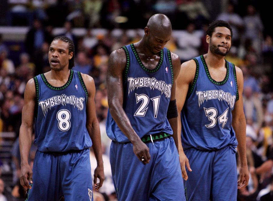 LOS ANGELES - MAY 25: (L-R) Latrell Sprewell #8, Kevin Garnett #21 and Michael Olowokandi #34 of the Minnesota Timberwolves walk out onto the court after a time out against the Los Angeles Lakers in Game three of the Western Conference Finals during the 2004 NBA Playoffs on May 25, 2004 at Staples Center in Los Angeles, California. NOTE TO USER: User expressly acknowledges and agrees that, by downloading and or using this photograph, User is consenting to the terms and conditions of the Getty Images License Agreement. (Photo by Jed Jacobsohn/Getty Images)