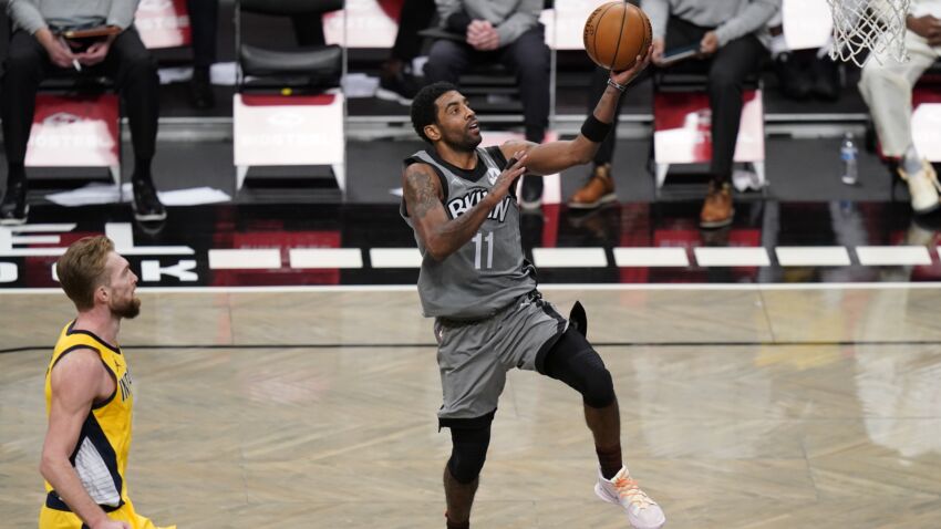 Brooklyn Nets' Kyrie Irving, right, drives past Indiana Pacers' Domantas Sabonis to score during the second half of an NBA basketball game Wednesday, Feb. 10, 2021, in New York. (AP Photo/Frank Franklin II)