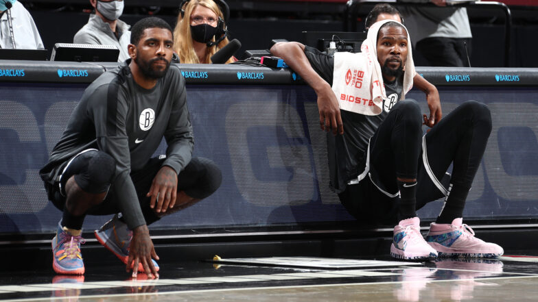 BROOKLYN, NY - December 13: Kyrie Irving #11 and Kevin Durant #7 of the Brooklyn Nets looks on during a preseason game against the Washington Wizards on December 13, 2020 at Barclays Center in Brooklyn, New York. NOTE TO USER: User expressly acknowledges and agrees that, by downloading and or using this Photograph, user is consenting to the terms and conditions of the Getty Images License Agreement. Mandatory Copyright Notice: Copyright 2020 NBAE (Photo by Nathaniel S. Butler/NBAE via Getty Images)