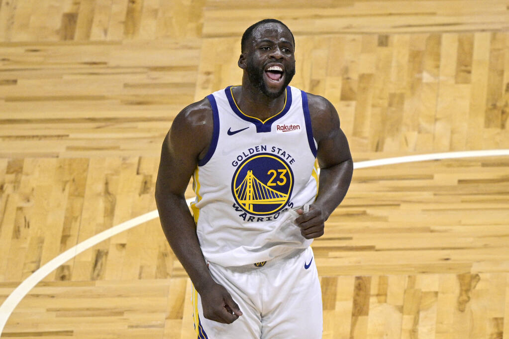 Golden State Warriors forward Draymond Green (23) celebrates after scoring a 3-point basket during the second half of an NBA basketball game against the Orlando Magic, Friday, Feb. 19, 2021, in Orlando, Fla. (AP Photo/Phelan M. Ebenhack)