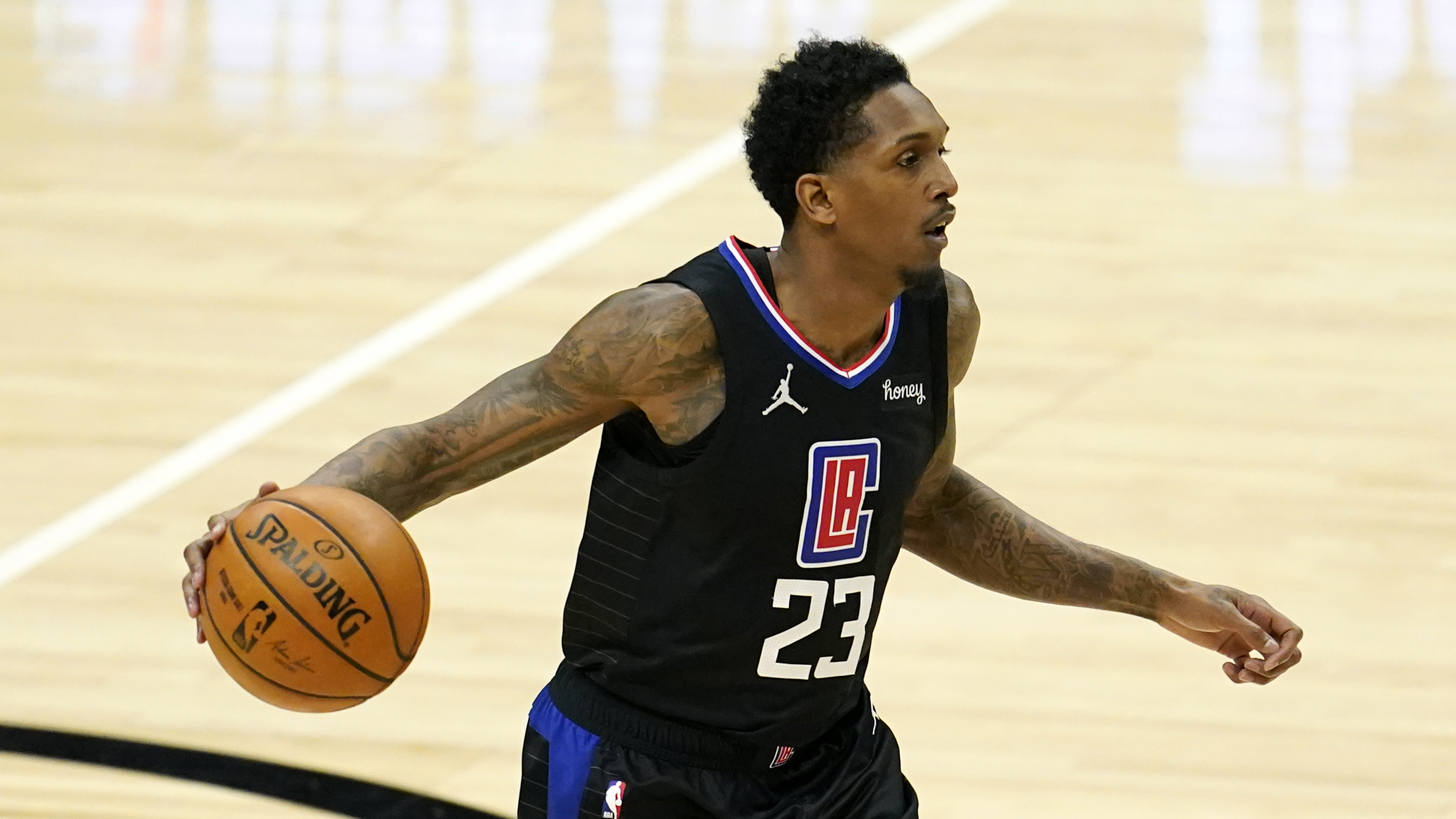 Los Angeles Clippers guard Lou Williams (23) dribbles during an NBA basketball game against the Golden State Warriors Thursday, March 11, 2021, in Los Angeles. (AP Photo/Marcio Jose Sanchez)