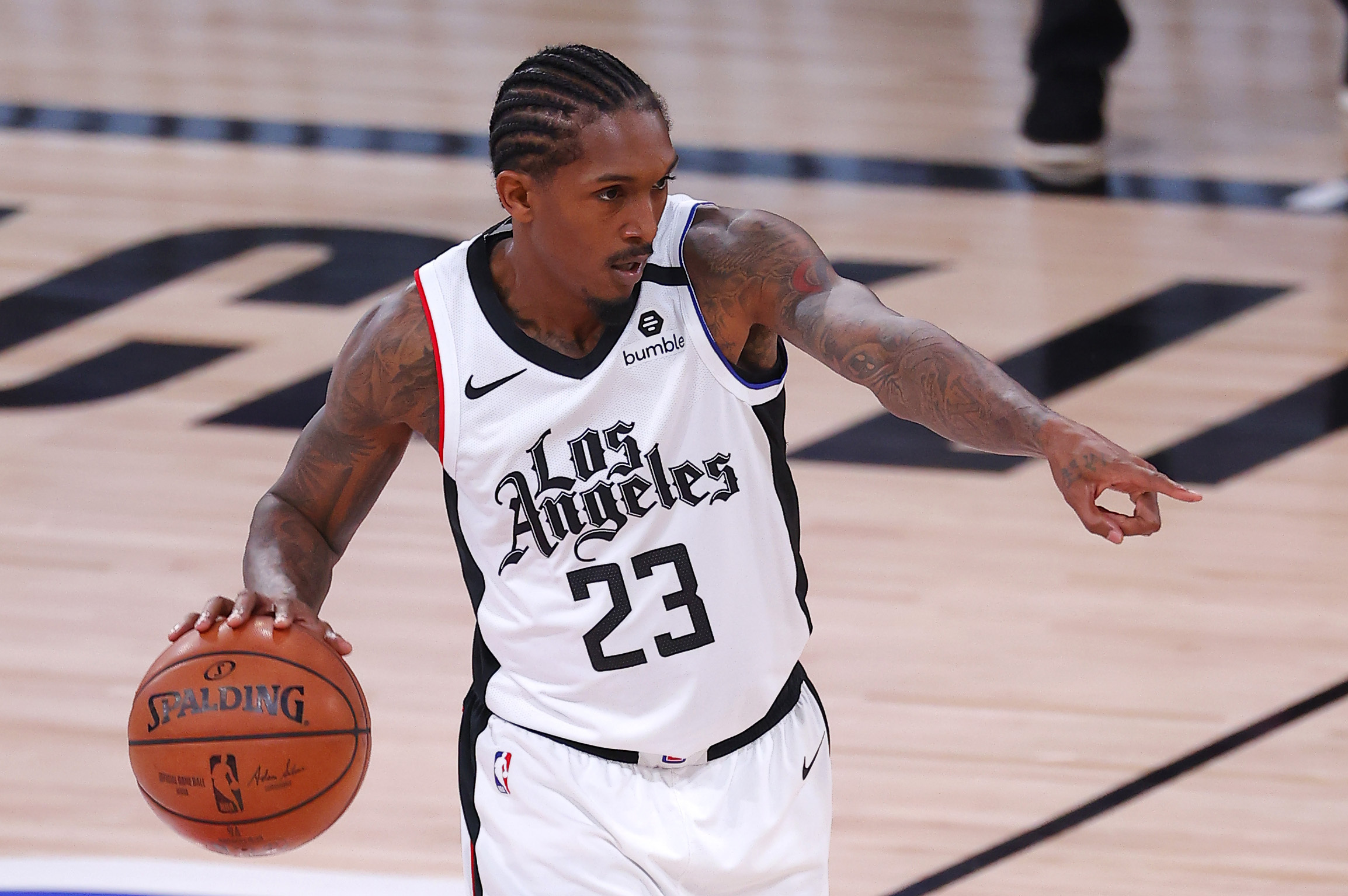 Los Angeles Clippers' Lou Williams (23) brings the ball upcourt against the Dallas Mavericks during the first quarter of Game 3 of an NBA basketball first-round playoff series, Friday, Aug. 21, 2020, in Lake Buena Vista, Fla. (Mike Ehrmann/Pool Photo via AP)