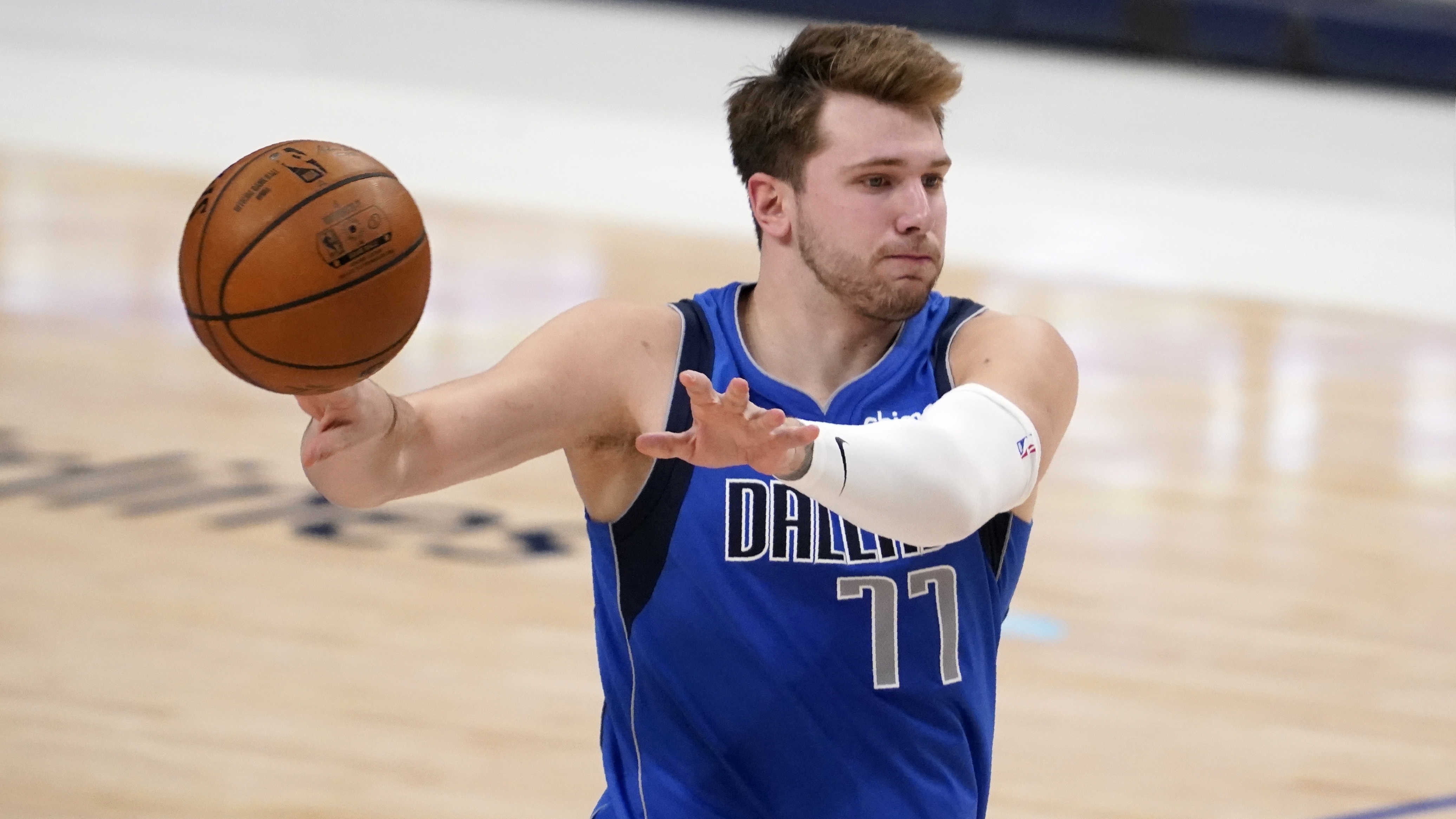 Dallas Mavericks guard Luka Doncic makes a pass in the second half of an NBA basketball game against the San Antonio Spurs in Dallas, Sunday, April 11, 2021. (AP Photo/Tony Gutierrez)