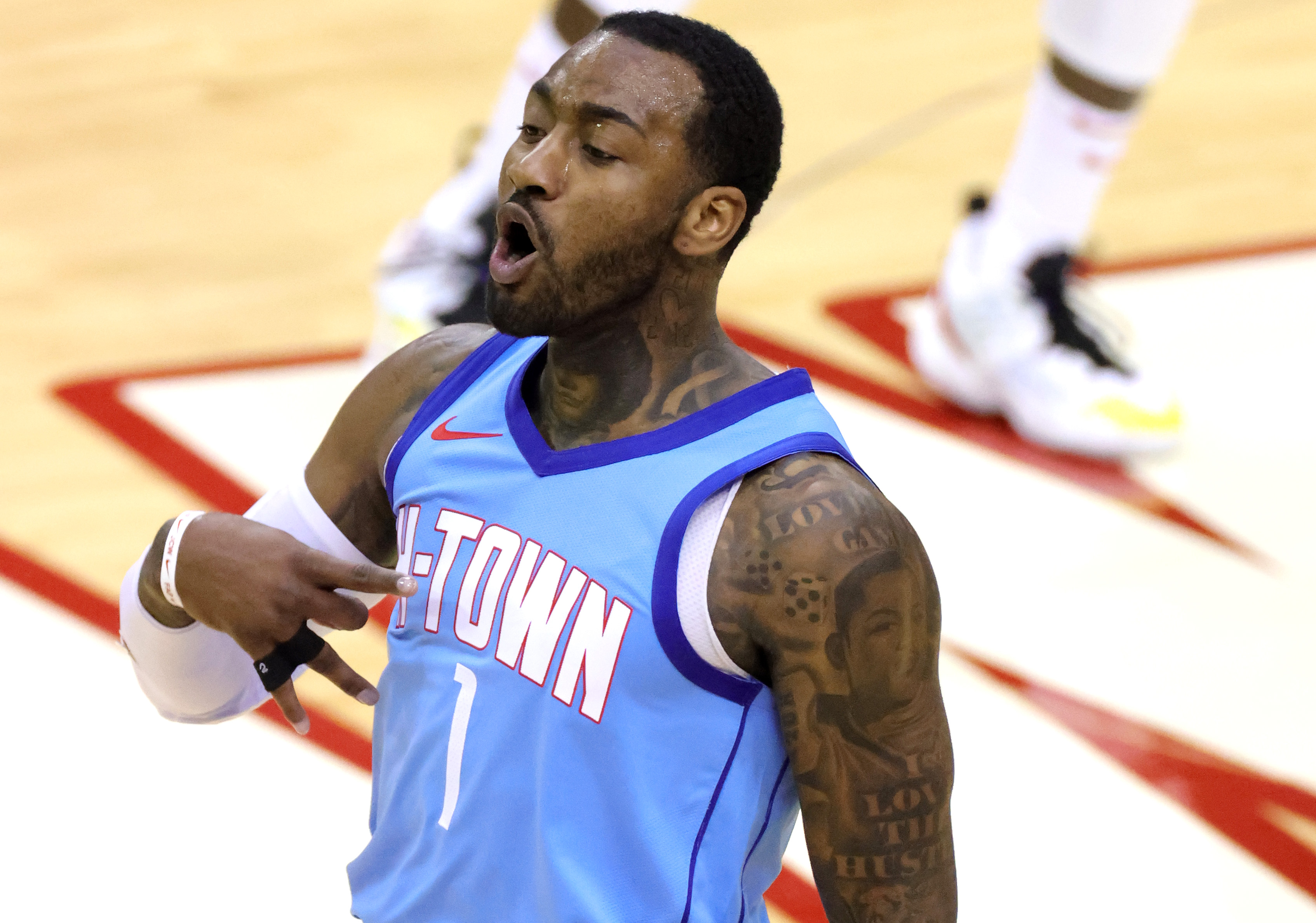 Jan 26, 2021; Houston, Texas, USA; Houston Rockets guard John Wall (1) reacts after making a three point basket against the Washington Wizards during the fourth quarter at Toyota Center. Mandatory Credit: Carmen Mandato/Pool Photo-USA TODAY Sports