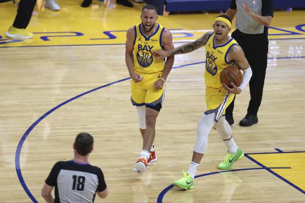 Golden State Warriors' Stephen Curry (30) and Juan Toscano-Anderson (95) yell at a referee during the second half of the team's NBA basketball game against the Denver Nuggets in San Francisco, Friday, April 23, 2021. (AP Photo/Jed Jacobsohn)