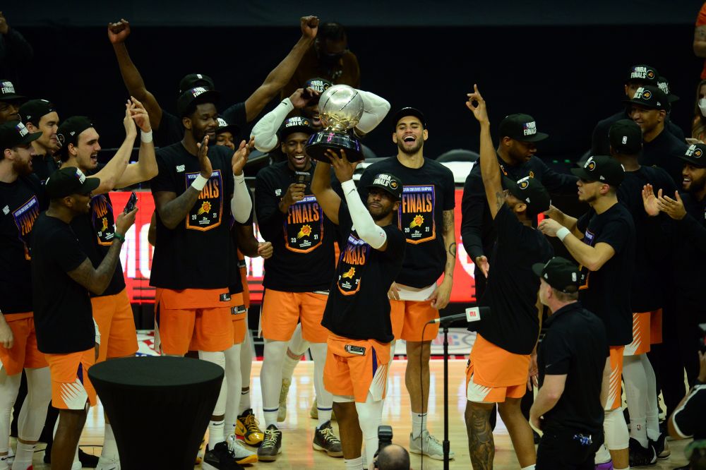 Jun 30, 2021; Los Angeles, California, USA; Phoenix Suns guard Chris Paul (3) lifts the Western Conference champions trophy following the series victory against the Los Angeles Clippers in game six of the Western Conference Finals for the 2021 NBA Playoffs at Staples Center. Mandatory Credit: Gary A. Vasquez-USA TODAY Sports