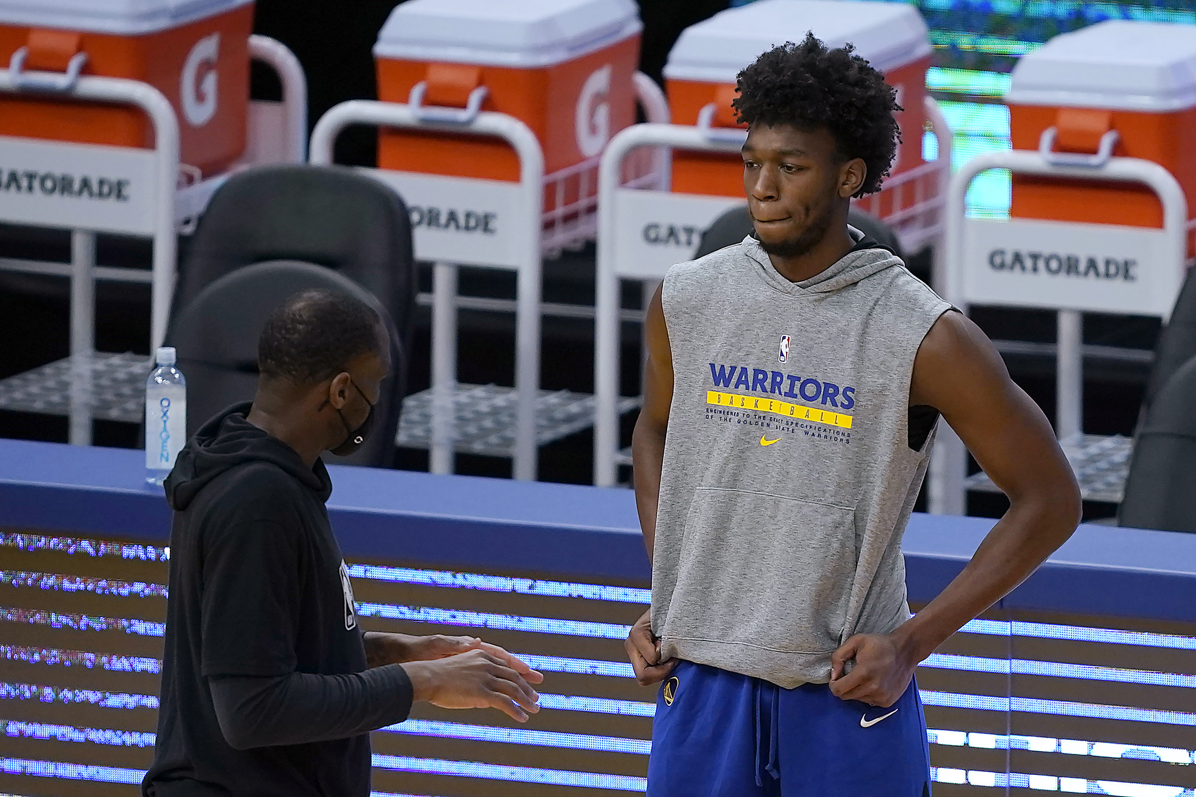 Golden State Warriors center James Wiseman talks with a coach before the team's NBA basketball game against the Portland Trail Blazers in San Francisco, Friday, Jan. 1, 2021. (AP Photo/Tony Avelar)