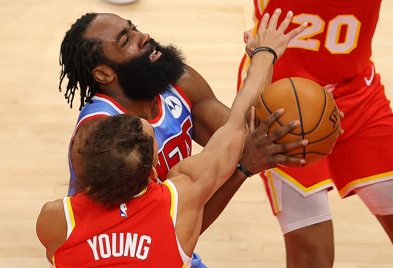 ATLANTA, GEORGIA - JANUARY 27:  James Harden #13 of the Brooklyn Nets draws a foul from Trae Young #11 of the Atlanta Hawks during the first half at State Farm Arena on January 27, 2021 in Atlanta, Georgia.  NOTE TO USER: User expressly acknowledges and agrees that, by downloading and or using this photograph, User is consenting to the terms and conditions of the Getty Images License Agreement.  (Photo by Kevin C. Cox/Getty Images)