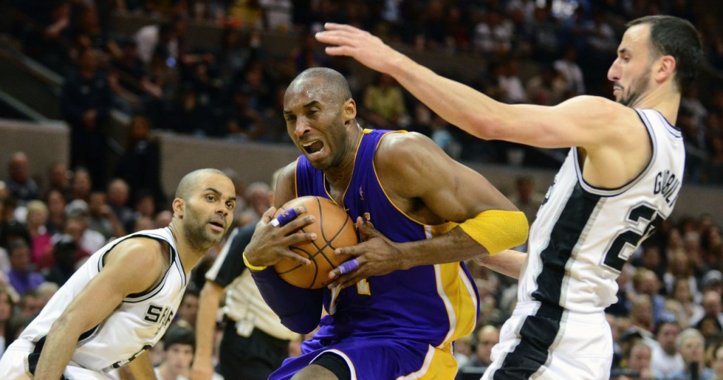 Los Angeles Lakers guard Kobe Bryant drives between the San Antonio Spurs' Tony Parker (9), of France, and Manu Ginobili, of Argentina, during the first half of an NBA basketball game at the AT&T Center in San Antonio, Sunday, March 6, 2011. (AP Photo/Bahram Mark Sobhani)