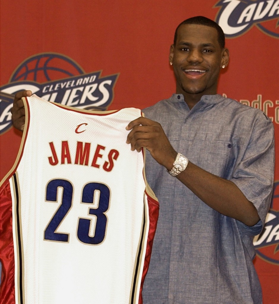 Cleveland Cavaliers' LeBron James, the first pick in the NBA draft, holds up his jersey during a news conference Friday, June 27, 2003, at Gund Arena in Cleveland. (AP Photo/Tony Dejak)