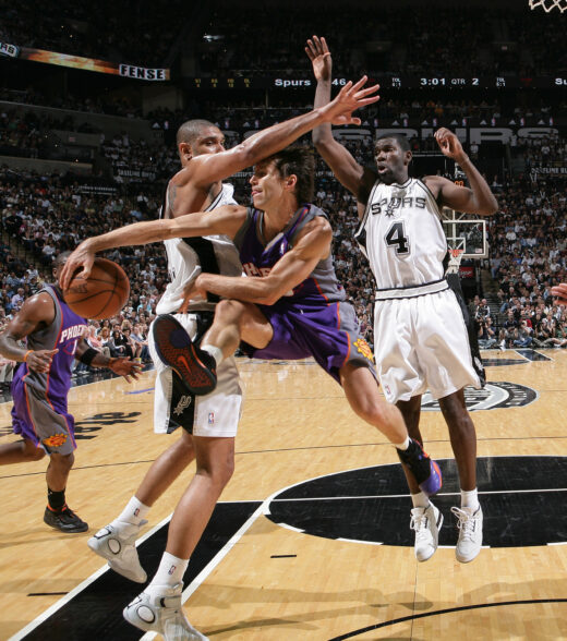 SAN ANTONIO - MAY 18: Steve Nash #13 of the Phoenix Suns passes against Tim Duncan #21and Michael Finley #4 of the San Antonio Spurs in Game Six of the Western Conference Semifinals during the 2007 NBA Playoffs on May 18, 2007 at AT&T Center in San Antonio, Texas. NOTE TO USER: User expressly acknowledges and agrees that, by downloading and or using this Photograph, user is consenting to the terms and conditions of the Getty Images License Agreement. Mandatory Copyright Notice: Copyright 2007 NBAE (Photo by Jesse D. Garrabrant/NBAE via Getty Images)