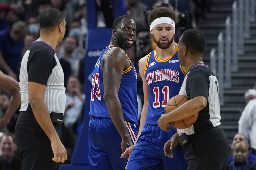 Golden State Warriors forward Draymond Green, middle, and guard Klay Thompson (11) look toward officials after Green was called for a technical foul during the first half of an NBA basketball game against the Boston Celtics in San Francisco, Wednesday, March 16, 2022. (AP Photo/Jeff Chiu)