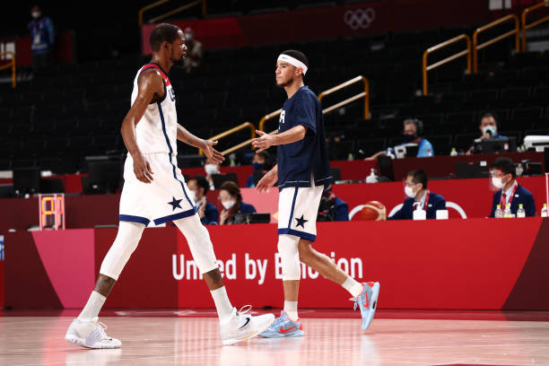 TOKYO, JAPAN - JULY 31: Kevin Durant #7 of the USA Men's National Team high fives Devin Booker #15 of the USA Men's National Team during the 2020 Tokyo Olympics on July 31, 2021 at the Saitama Super Arena in Tokyo, Japan. NOTE TO USER: User expressly acknowledges and agrees that, by downloading and or using this photograph, user is consenting to the terms and conditions of the Getty Images License Agreement. Mandatory Copyright Notice: Copyright 2021 NBAE (Photo by Ned Dishman/NBAE via Getty Images)