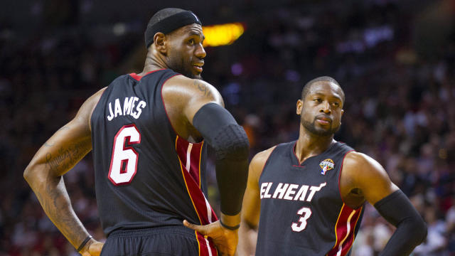 Mar 6, 2013; Miami, FL, USA; Miami Heat small forward LeBron James (6) and Heat shooting guard Dwyane Wade (3) react to some fans during the game against the Orlando Magic at the American Airlines Arena. Mandatory Credit: Scott Rovak-USA TODAY Sports